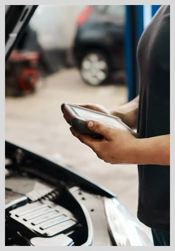 A technician inspecting a vehicle's engine