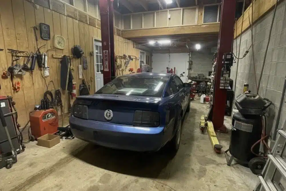 Car Maintenance Service in Canadian Lakes, MI At 2nd Mile Repair. Image of Blue Ford Mustang inside a repair bay for expert car maintenance.
